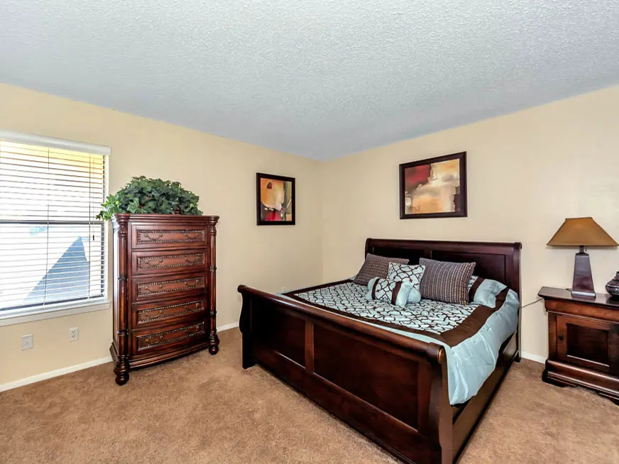Primary bedroom with carpet and a large window