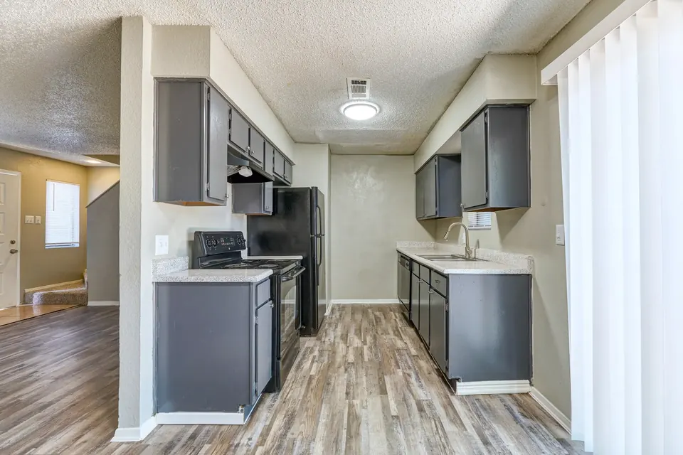 Galley kitchen with grey cabinets in a renovated 2-bedroom Modern Grey townhome