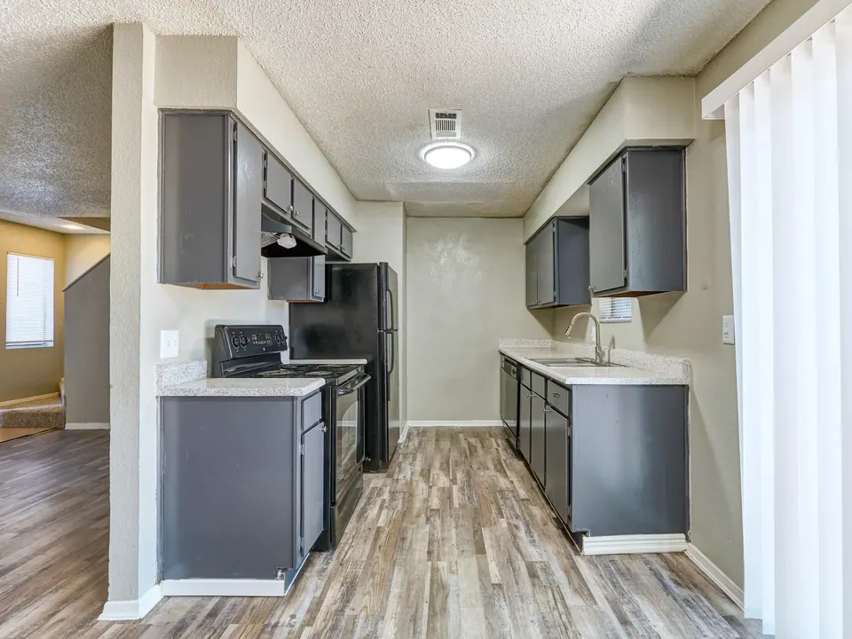 Galley kitchen with grey cabinets in a renovated 2-bedroom Modern Grey townhome