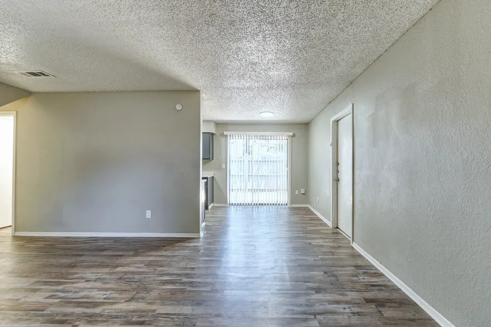 Open living area with vinyl plank floors in a renovated Modern Grey townhome